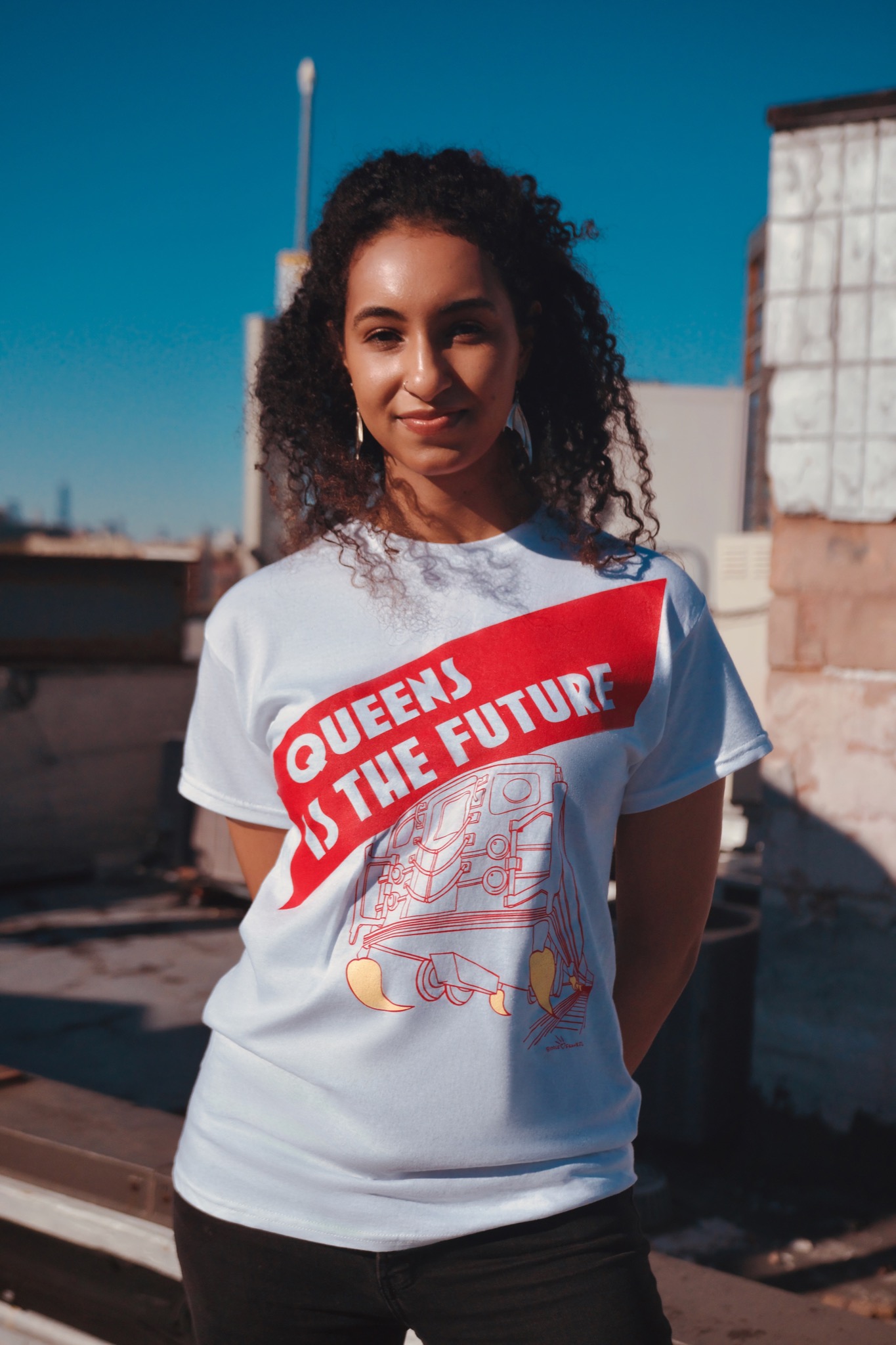 Official Queens Is The Future T-shirt worn by a young woman